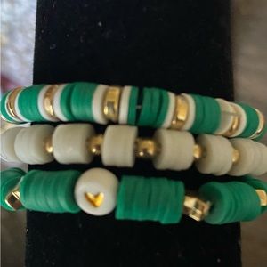 Bracelet set of three dark green and gold themed.